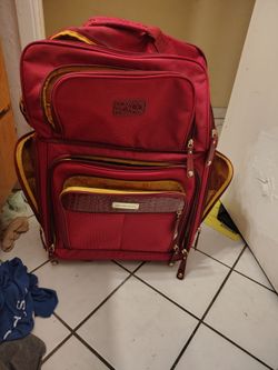 Burgundy Samantha brown croco embossed rolling underseater featuring a glossy texted front pocket and polished gold tone hardware 23 inches high