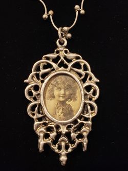 $10. Vintage looking nouveau silver tone metal necklace with vintage looking picture. Dimensional scroll magic.