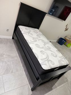 2 Twin bed frames with mattresses/ box springs.