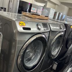 SAMSUNG FRONT LOAD WASHER AND GAS DRYER SET ON PEDESTAL 