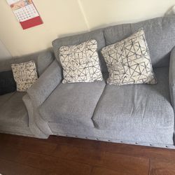 Matching couch and love seat with matching decorative pillows