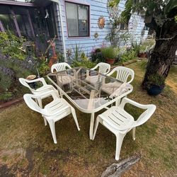 Glass top table and six stackable chairs Glass top table and six stackable chairs