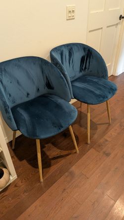 Two velvet blue chairs