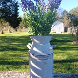 Brand new Faux Lavender flowers in antique metal vase.