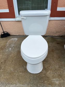 Clean toilet in good condition; measures 17 inches high.