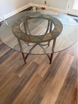 Round glass /Metal dinning table .