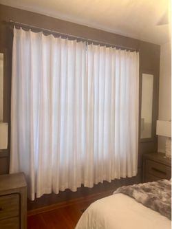 White drapery panels with heavy metal modern hangers