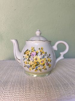 Vintage elegant white with yellow floral design ceramic teapot with lid