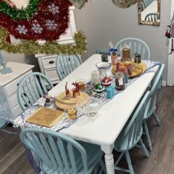 White table with six chairs in seafoam green