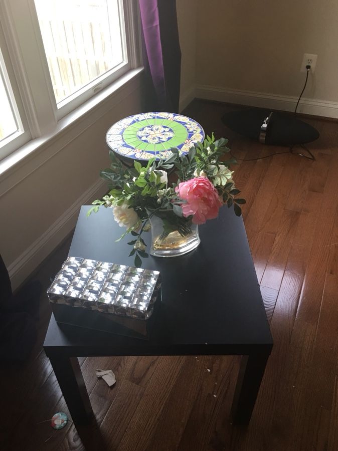 Black coffee table, mirrored box and acrylic floral arrangement