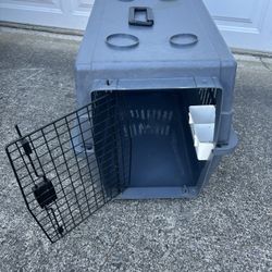 Medium size dog kennel in good condition, has place for water inside also.  measures 26 inches long 17 inches wide and 18 inches tall.  $40, cash or V