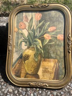 vintage-style painting features a still life of tulips in a vase housed in an ornate, curved gold frame