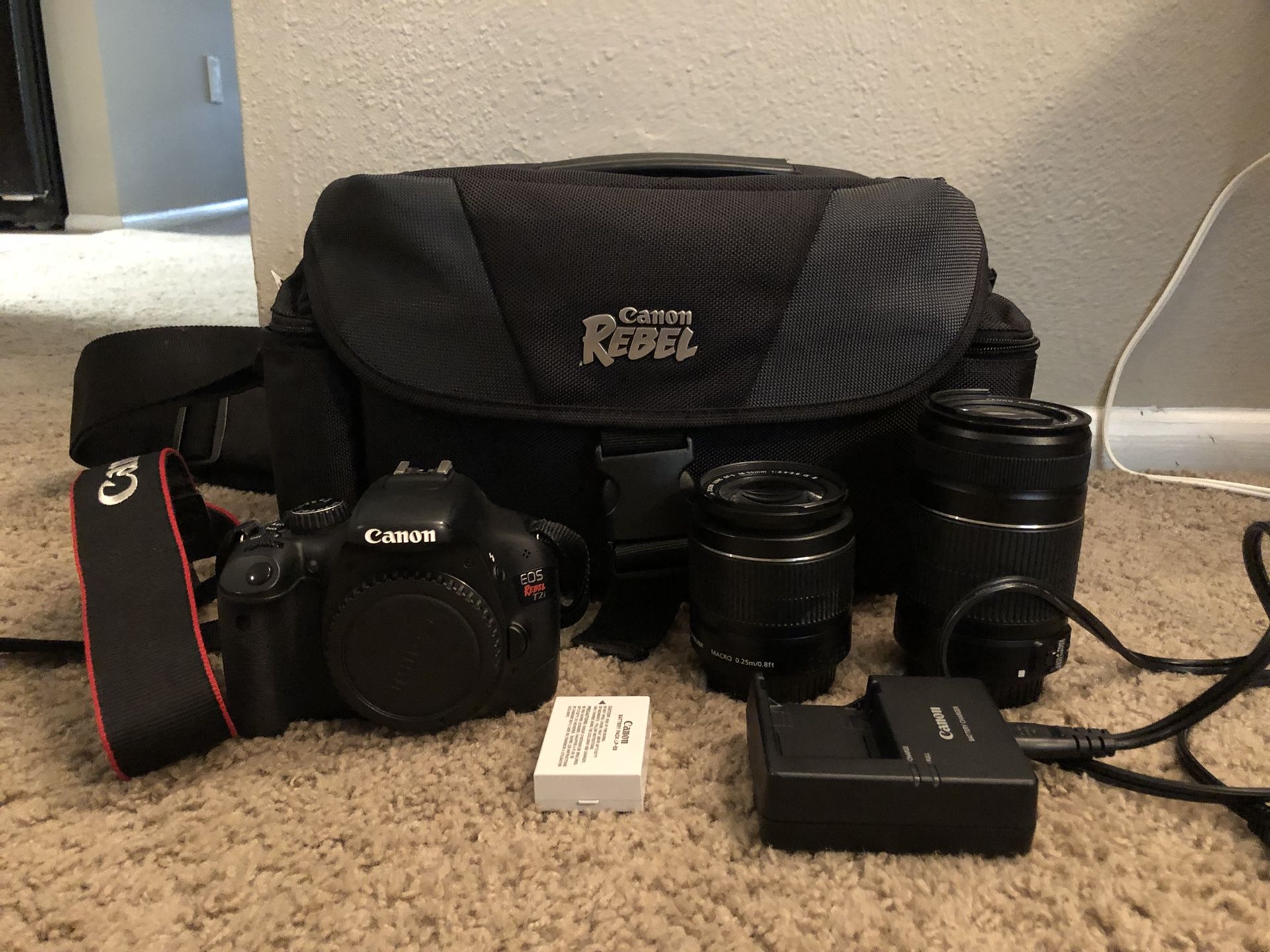 Canon T2i with two lenses (efs 18-55mm and efs 55-250mm), bag, charger, and battery