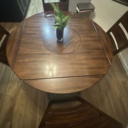 4.5 ft   kitchen table w/lazy suzy center, 4 black leather chairs