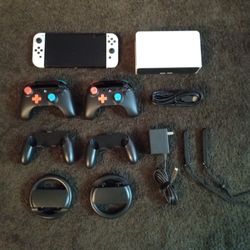 NINTENDO SWITCH OLED and 120 GAMES + EXTRA CONTROLLERS and WHEELS 