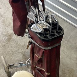 Vintage Titleist golf clubs with vintage cart and seat and rain Hood