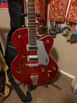 Gretsch 5420t red sparkle with hardtail, bigsby, and hardshell case.