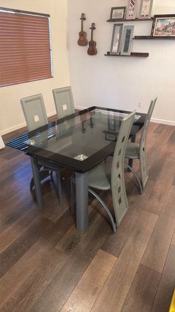 Modern style glass table with four chair chairs