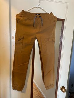 Youth Brown Cargo Jogger Pants (Elastic Waist) Style: Brown cargo joggers with drawstring waist and elastic cuffs. Features: Multiple pockets (si
