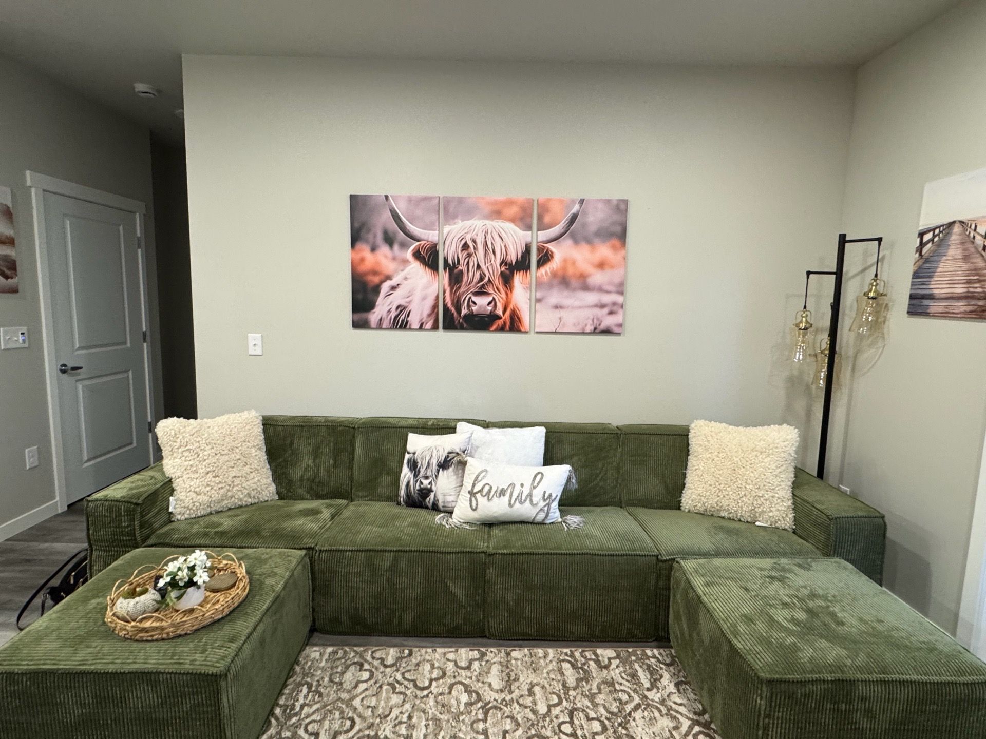 Green couch with two Ottomans.