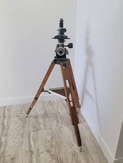 Vintage surveying transit on a wooden tripod