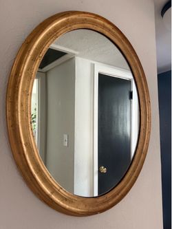 Oval mirror with distressed gold trim