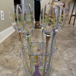Set of 6 champagne/wine toasting flutes with elongated colorful stems. 