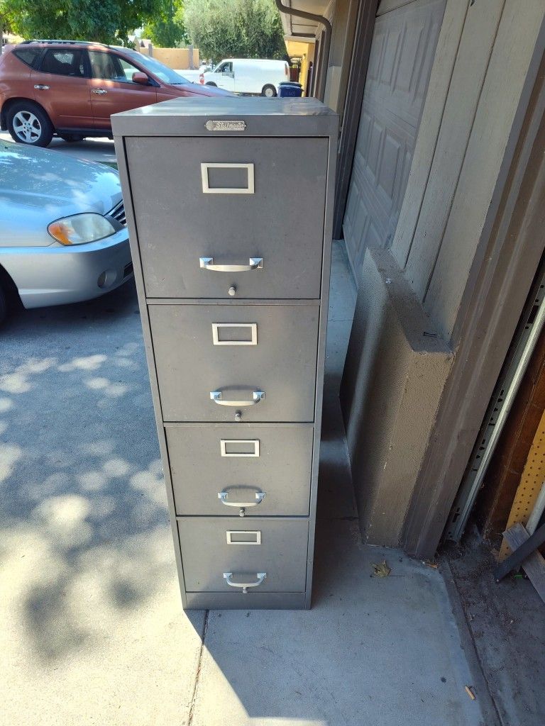 Tall Filing Cabinet. Drawers Roll Without Issues 