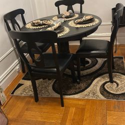 Dining Table With Four Chairs, Area Rug And Table Decoration 