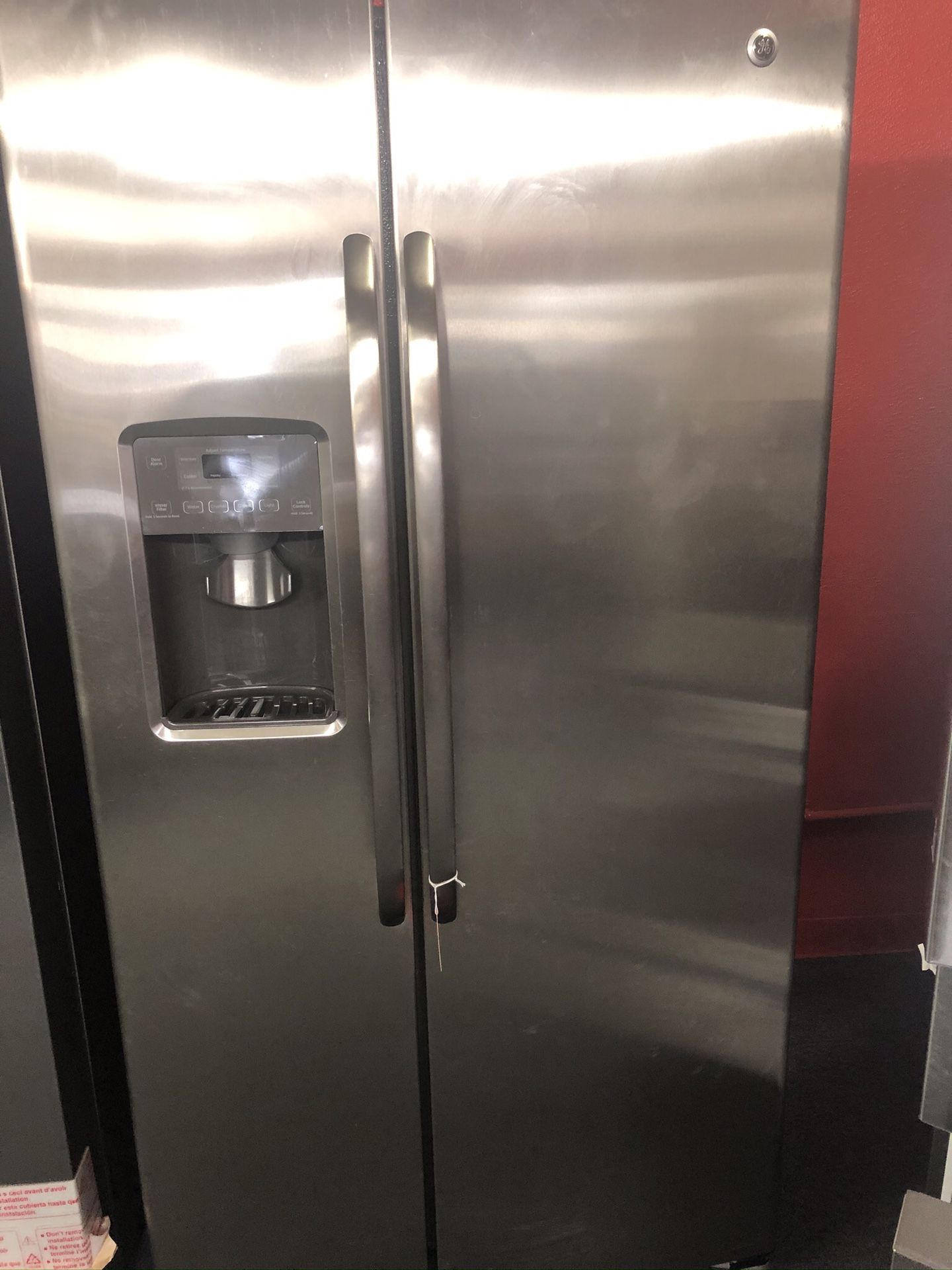 Used GE 27 cu ft stainless steel side by side fridge. 1 year warranty