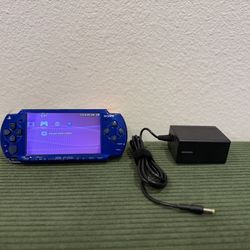 blue PSP 2000, includes battery and AC adapter