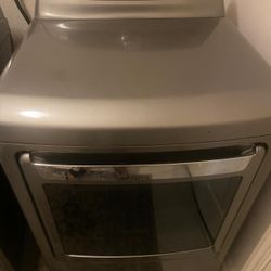 Kenmore Elite Steam Dryer in a graphite steel finish, featuring a large capacity stainless steel drum and a versatile door design. 