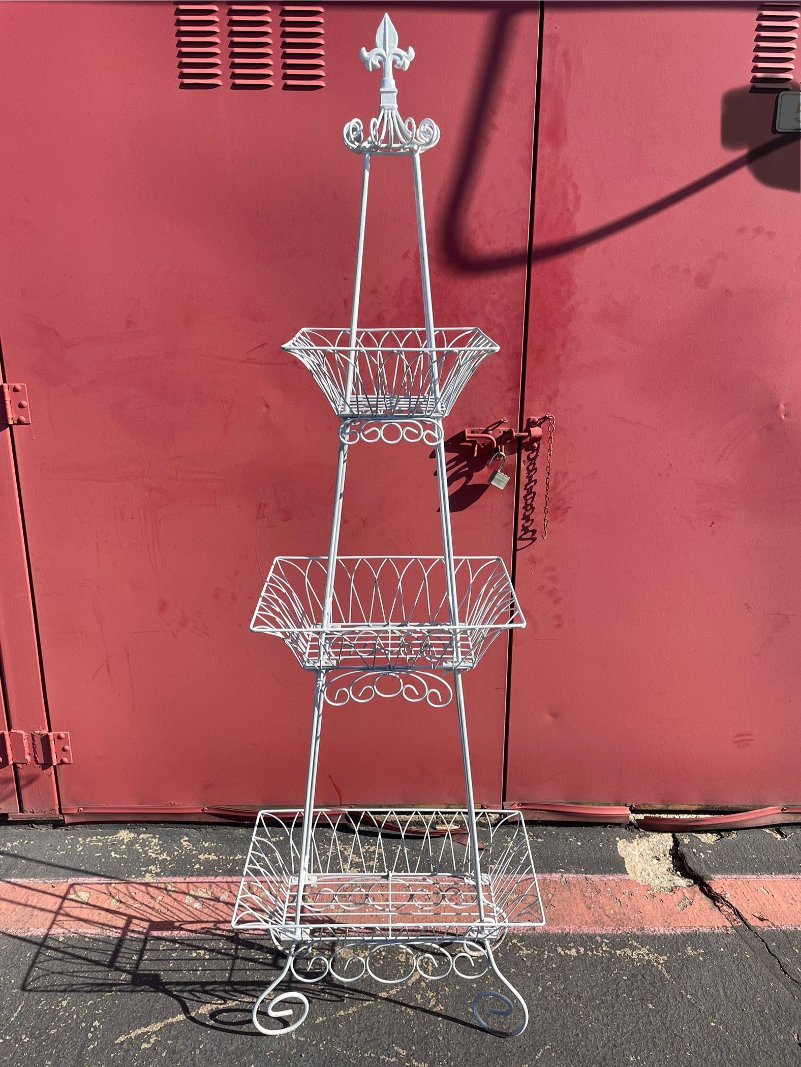 Metal tower three tier stands are versatile and used for displaying potted plants, flowers