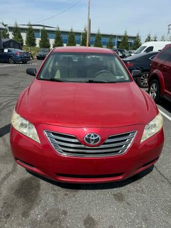2007 Red Toyota Camry LE Sedan.