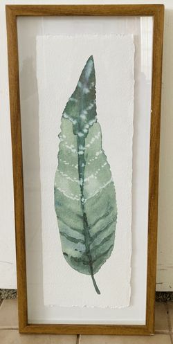 One Glass/Wood Framed Green Leaf Artwork 12” wide x 28” high 
