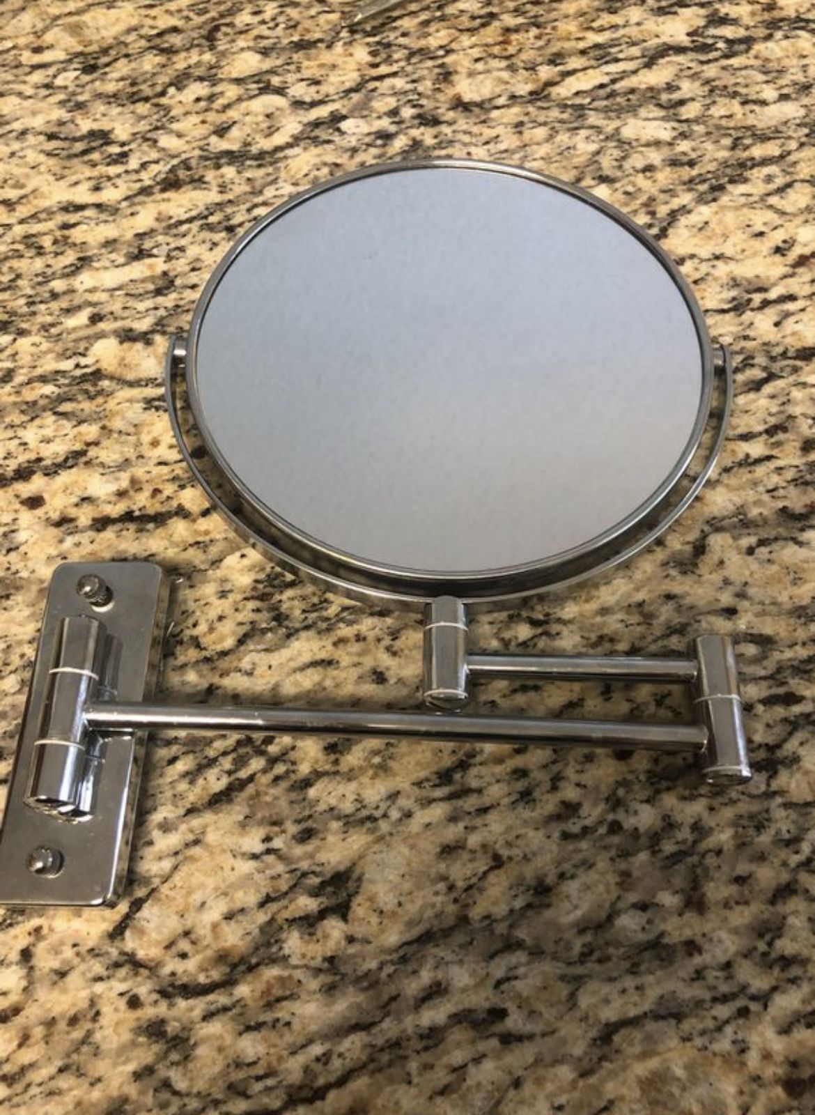 Wall mounted bathroom mirror with magnification