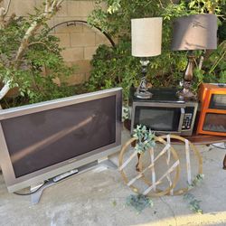 Tv. Microwave. Heater. 2 Lamps. And 2 Picture Frames. Coffee Table