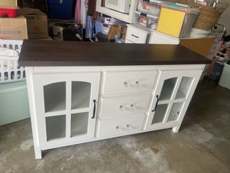 White Farmhouse-style media console dark wood top glass panel cabinet doors