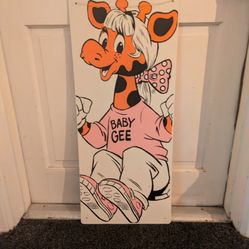 Vintage Toys R Us signage featuring "Baby Gee"