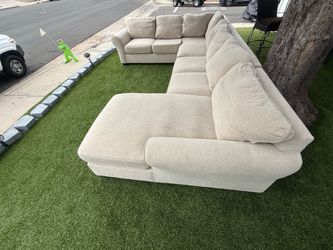 four-piece beige U-shaped sectional sofa / couch