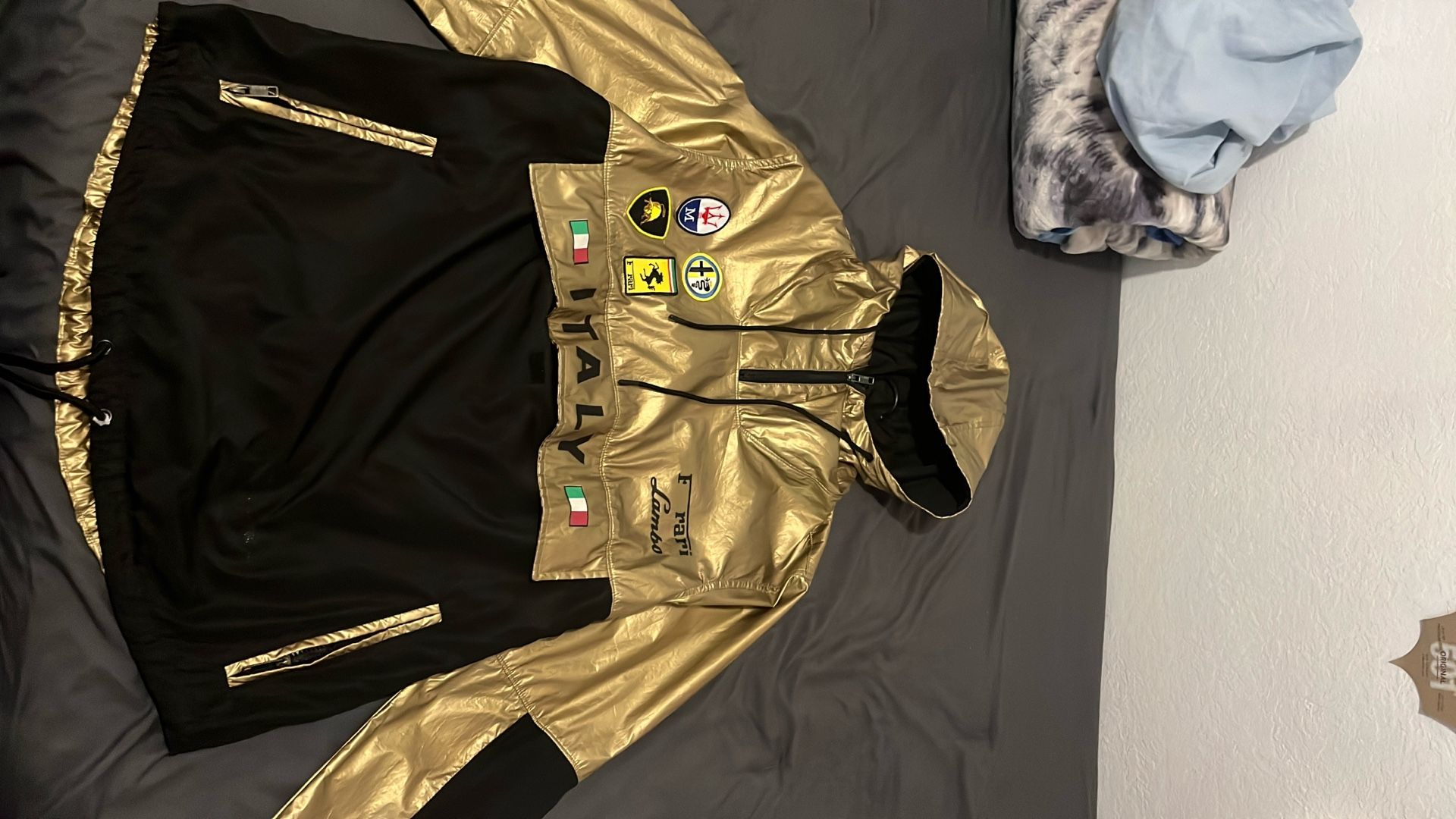 gold-and-black pullover windbreaker hoodie