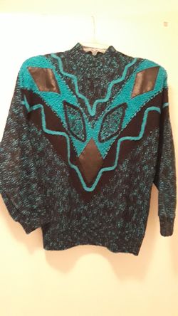 Sweater with leather inserts.