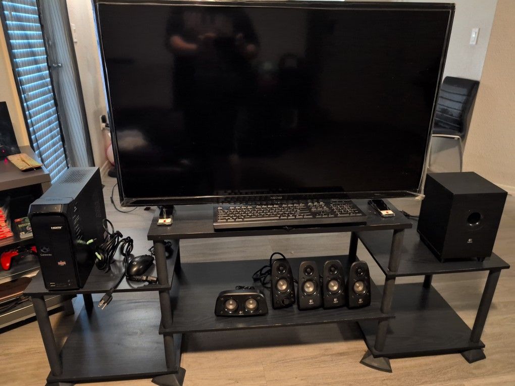 Insignia Television W/ speaker setup/computer tower/ keyboard/mouse