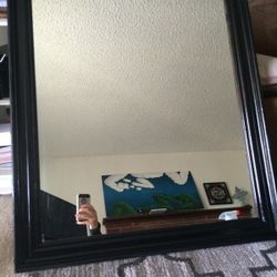 Large glossy black wooden mirror