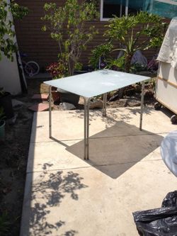 Glass top dinning table with metal legs
