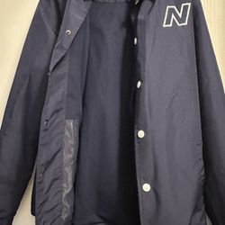 New Balance Athletics Coach Jacket, featuring a classic navy color