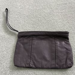 Vintage gray leather clutch with zipper and wristlet strap featuring black lining 11” x 4”