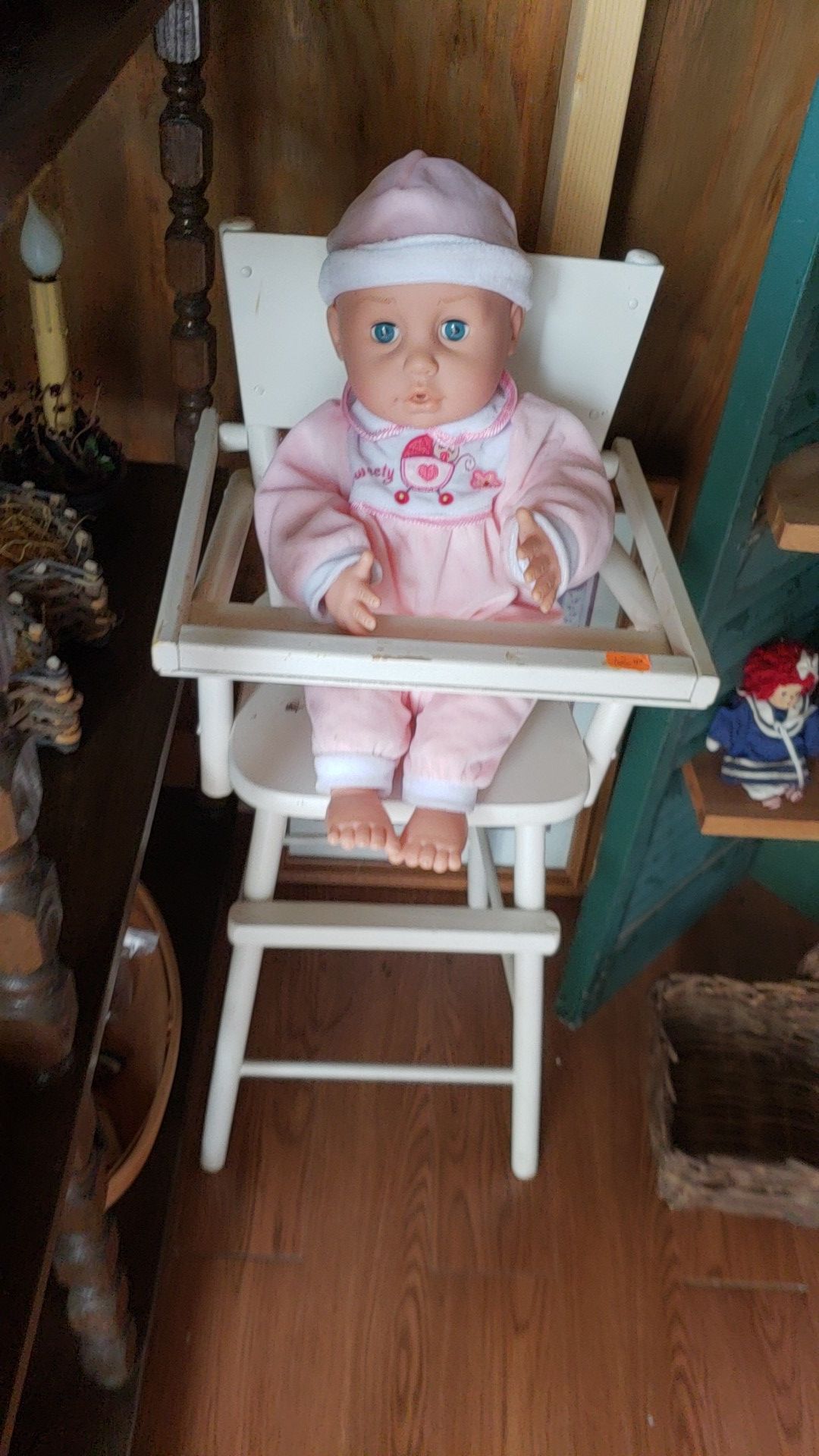 Babydoll and wooden highchair