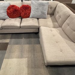 L-Shaped Beige Couch With Pillows 