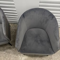 Set of 2 modern gray velvet accent chairs.
